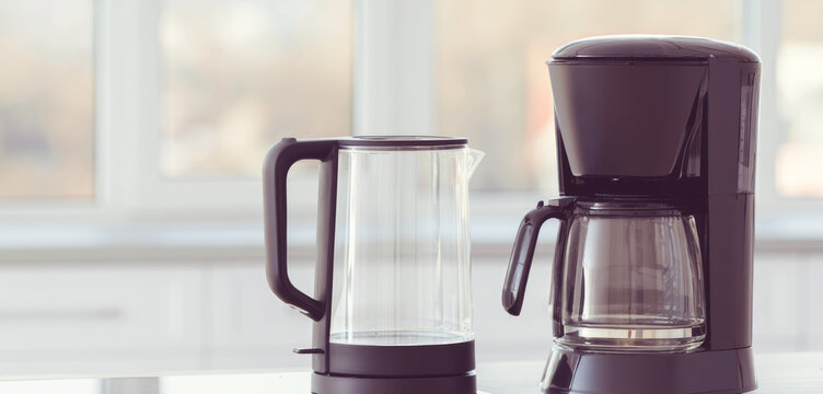 Coffee maker and glass electric kettle on a bright kitchen counter, representing everyday brewing, morning routine, and home beverage preparation