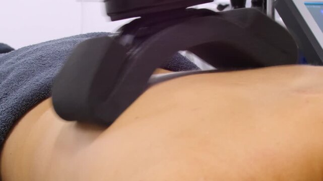 Professional body shaping therapy with vibromassage thermo vacuum and bioelectrical stimulation in beauty salon. 