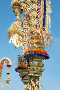 Penjor. Colorful penjor decorations rise high against blue sky