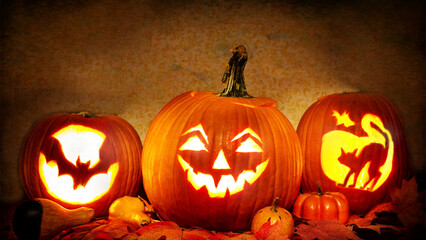 Row of carved glowing jack o lantern pumpkins lit in dark © Sushant