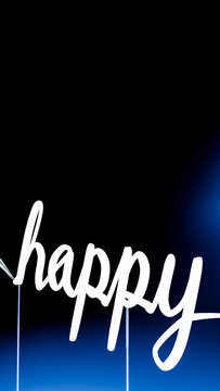 Handwriting of happy word with white brush ink on black background