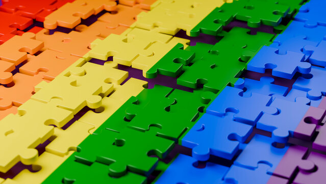 Colorful plastic jigsaw puzzle pieces in spectrum arrangement