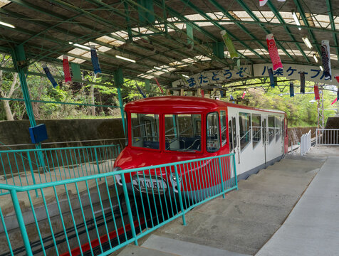 Takamatsu, Kagawa prefecture, Japan - April 16, 2018: Yakuri Cable funicular wagon stopped at the station on a slanted mountain slope