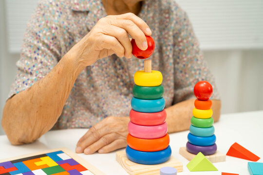 Asian elderly woman playing game.