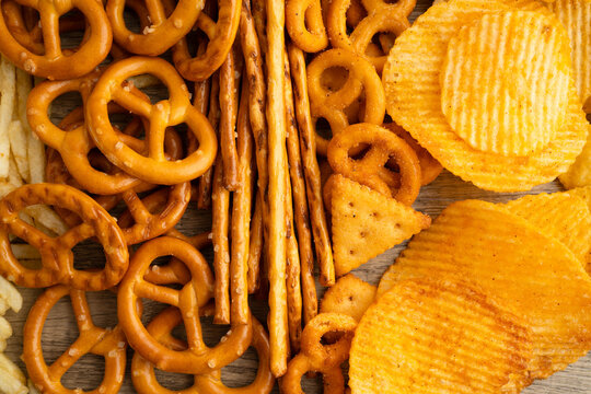 Mix of variety snack chips pretzel and cracker, junk crunchy food.