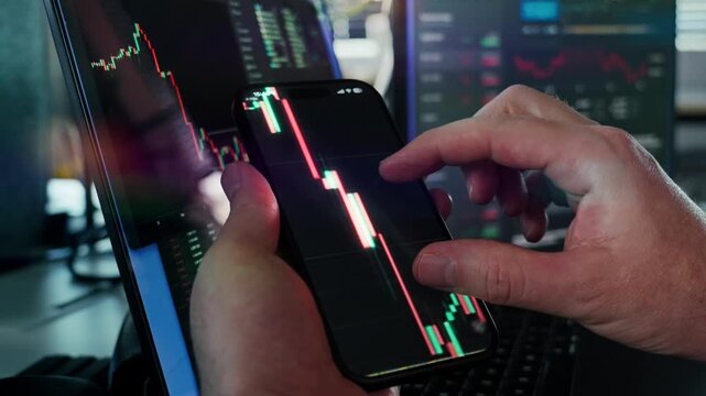 Close-Up of Hands Analyzing Stock Market Trends on a Smartphone, Candlestick Charts and Mobile Trading Technology