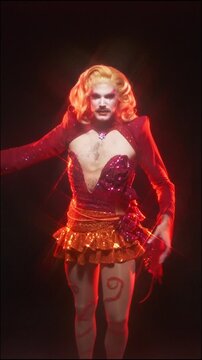 Flamboyant drag queen dancing in a shiny costume