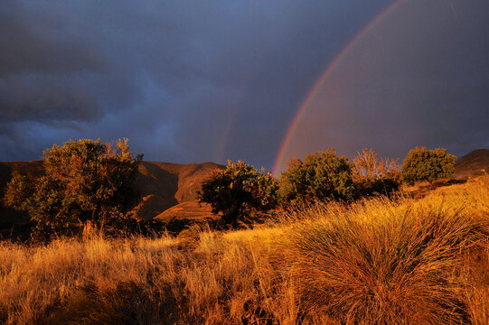Rainbow and thunderstorm near Granada foothills, Spain