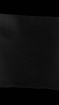 Vertical video: Opening cut revealing torn paper, crumpling and taping showing black negative space