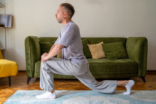 Hip flexor stretch and lunge exercise for lower body mobility and flexibility, middle aged man practicing home fitness workout and muscle stretching for active lifestyle