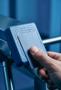 Person using a security badge at a turnstile