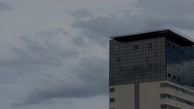 Modern Glass Building Facade Under Overcast Gray Sky