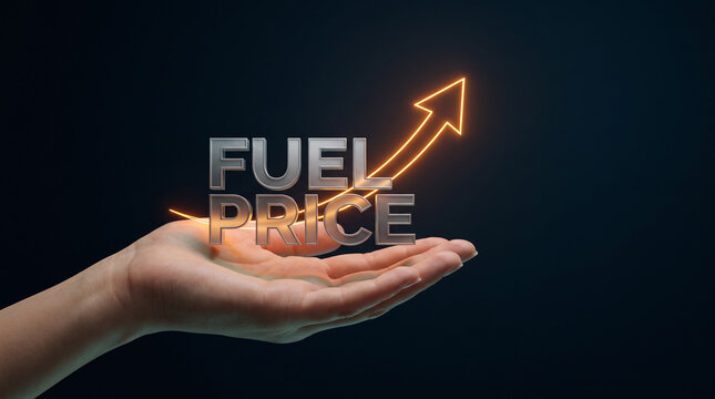 A hand holding a floating fuel price text and upward arrow showing a fuel price high, inflation, and rising energy costs