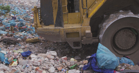 Close up of landfill with piles of litter and dozer © WavebreakMediaMicro