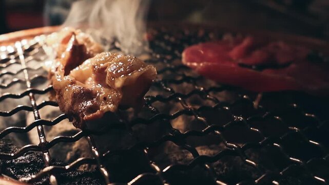 Grilled meat steak on stainless grill depot with flames on dark background. Food and cuisine concept. Copy space image. Place for adding text or design