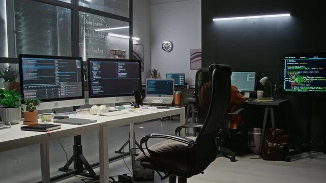Asian and Indian young adult software developers coding on computer monitors in office time lapse. Footage fits IT recruiting campaigns, cyber security promos, and tech presentations