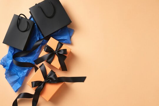 Elegant black shopping bags with blue tissue paper surround stylish gift boxes, perfect for festive occasions
