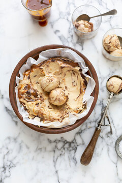 Caramel ice cream with chocolate swirl served in wooden container