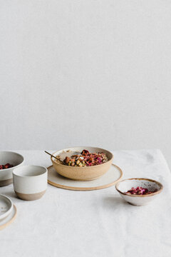 Porridge with chia seeds, pistachios, rose petals, tahini paste