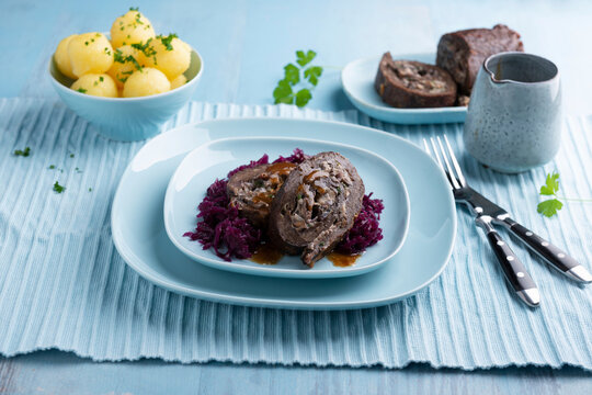 Vegan seitan roll roast with mushroom and onion filling, red cabbage