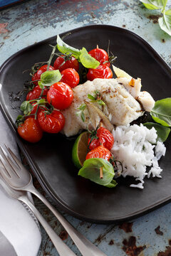 Rolled cod fillet with grilled cherry tomatoes and white rice