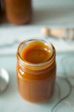 Salted caramel in small glass jar with screw top lid