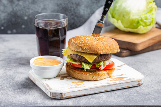 Burger with beef patty, Cheddar cheese, lettuce, tomato