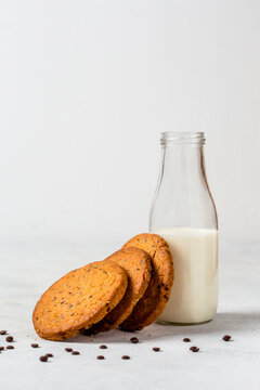 Cookies with Milk in a glass bottle on white background
