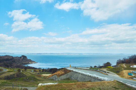 青い海と棚田の間をぬうように走る美しい海岸沿いのカーブ道路
