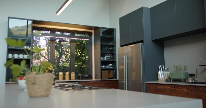 Kitchen island is anchoring, featuring gas cooktop, woven planter, window showing trees and hill