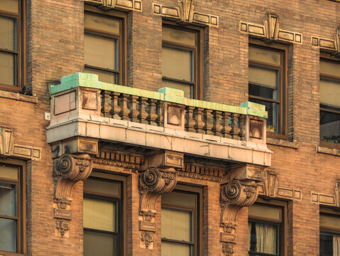 Ornate Balcony with Balustrade on Historic Brick Apartment Building Facade