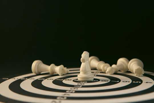 White chess pieces on a black background. The concept of business strategy.