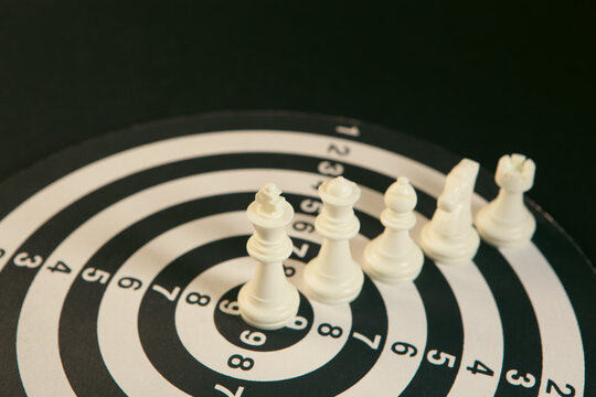 White chess pieces on a black background. The concept of business strategy.
