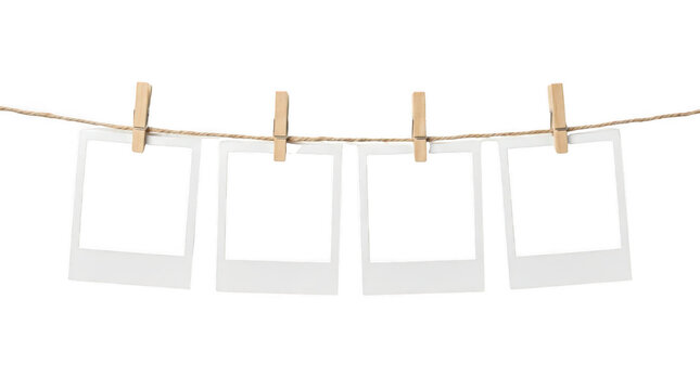 Blank photo frames hanging on a rustic string. Empty instant picture frames for scrapbooking projects isolated on Transparent Background