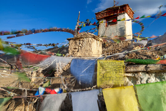 Prayer flags fluttering in the wind around a whitewashed shrine on a hilltop, Ladakh, Lamayuru, India