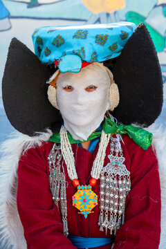 Ladakhi woman wearing the Perak and a white face mask with silver and pearl jewelry, Ladakh, Leh, India