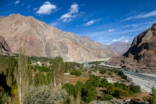 Green village and river in a mountain valley seen from above, Ladakh, Turtuk, India