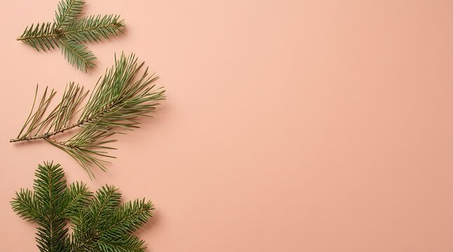 Festive pine branches and golden glitter arranged on a soft pastel pink background