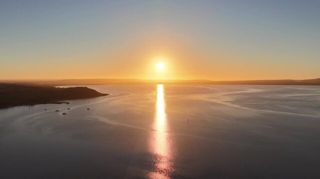Kingscote, Kangaroo Island, South Australia &ndash; 4K aerial drone view of golden sunset over Bay of Shoals and North Cape from Reeves Point, fishing boats and marina, peaceful bay, glowing sea reflections