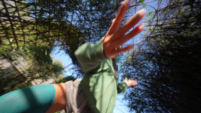 Woman extending her hands toward the camera during outdoor warm-up