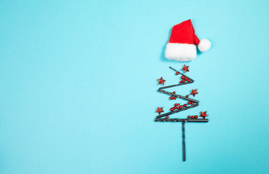 Christmas tree made from drill, red stars, baubles and Santa Claus hat, holiday greeting card, banner or background for handyman, craftsman or repairman, advent winter season