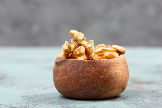 Walnuts in a wooden bowl, healthy nuts food, nutrition, ingredients for baking, protein and antioxidants