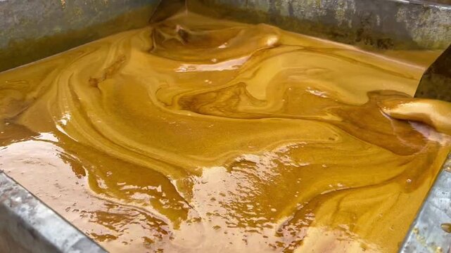 Traditional Gur Making Process with Hot Sugarcane Syrup in a Rural Production Setting