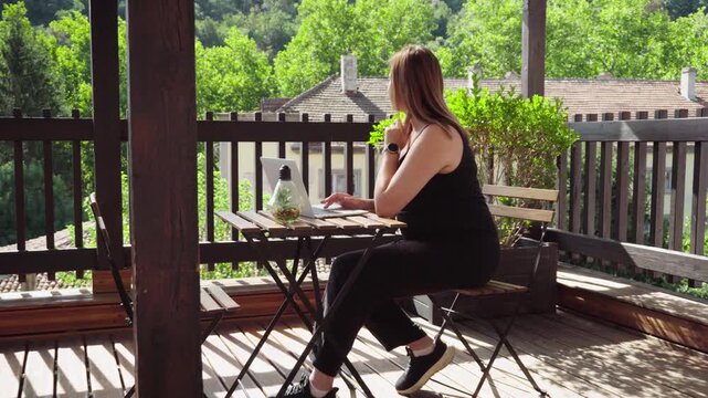 Freelancer Researching Online and Thinking Over Project on Outdoor Terrace