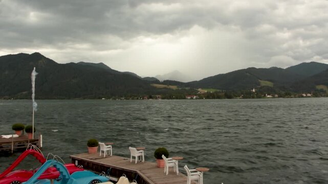 Catamarans Rocking on the Waves and a Flag Blowing in the Wind during a Storm on Lake Tegernsee, Bavaria, Germany, 3x Fast Motion, July 2024