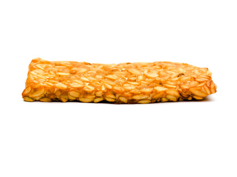 Eye-level front view of a thin rectangular raw tempeh piece isolated on a white background. Perfect stock image for healthy eating and vegan concepts.
