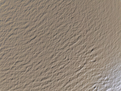 close up view of fine sand texture on wet beach surface in wenzhou