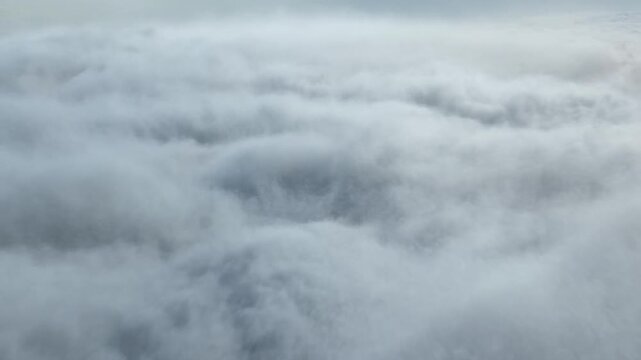 Dense dark gray storm clouds cover the overcast sky in a layered cloudscape
