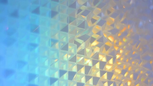 Pastel geometric pattern of faceted shapes in soft pink, purple, and blue light