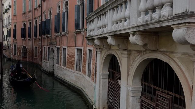 Gondolier Rowing Through Misty Venetian Historic Canal